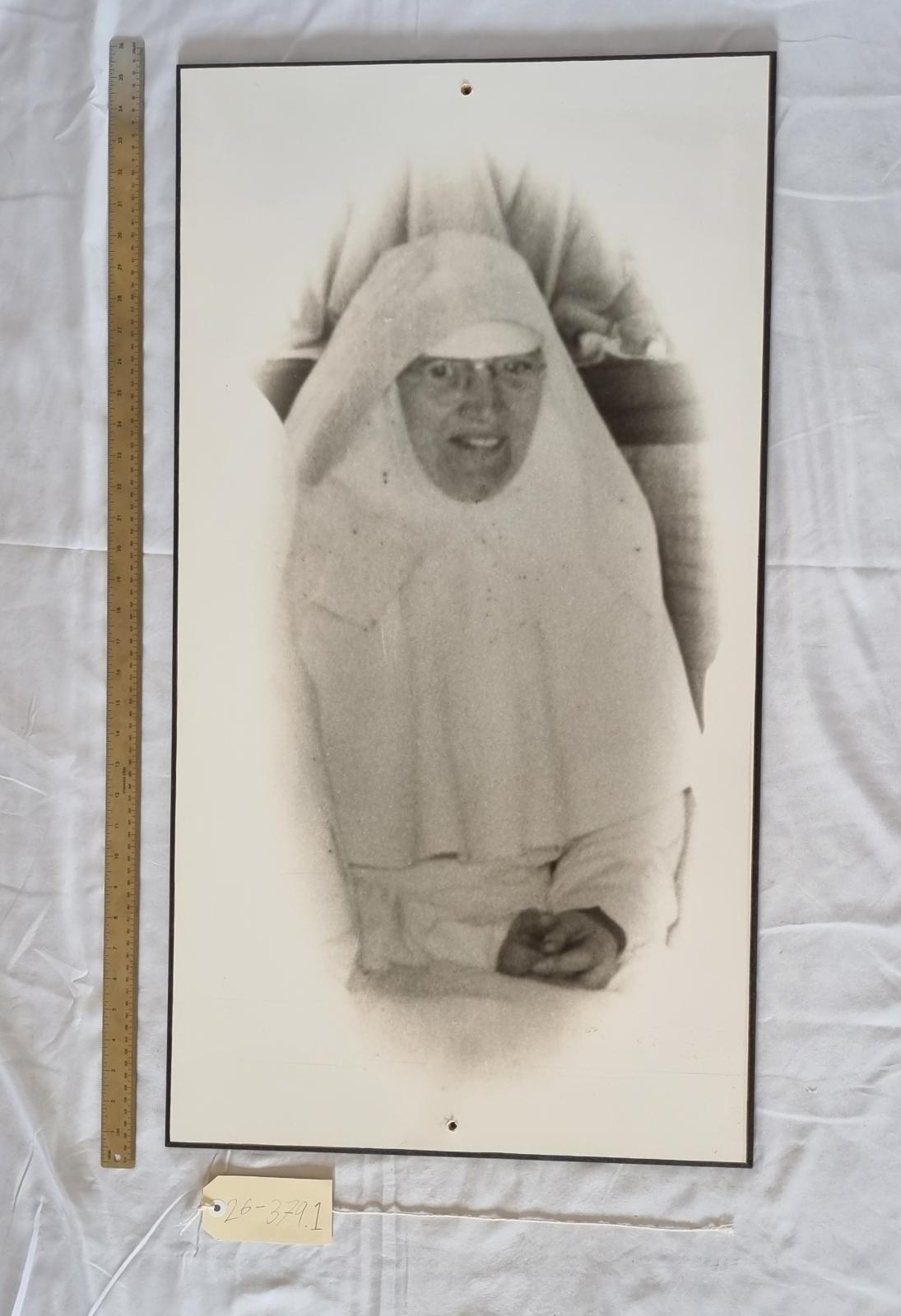 26-379.1 Large black and white portrait of Sister Rosanne Fox RSM photo with scale and tag.