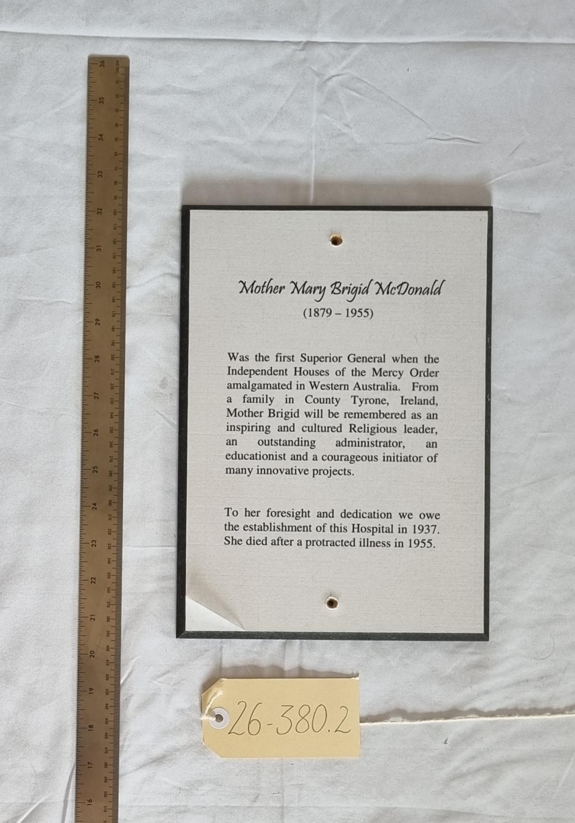 26-380.2 Woodblock-print of description of Mother Brigid McDonald RSM photo with scale and tag.
