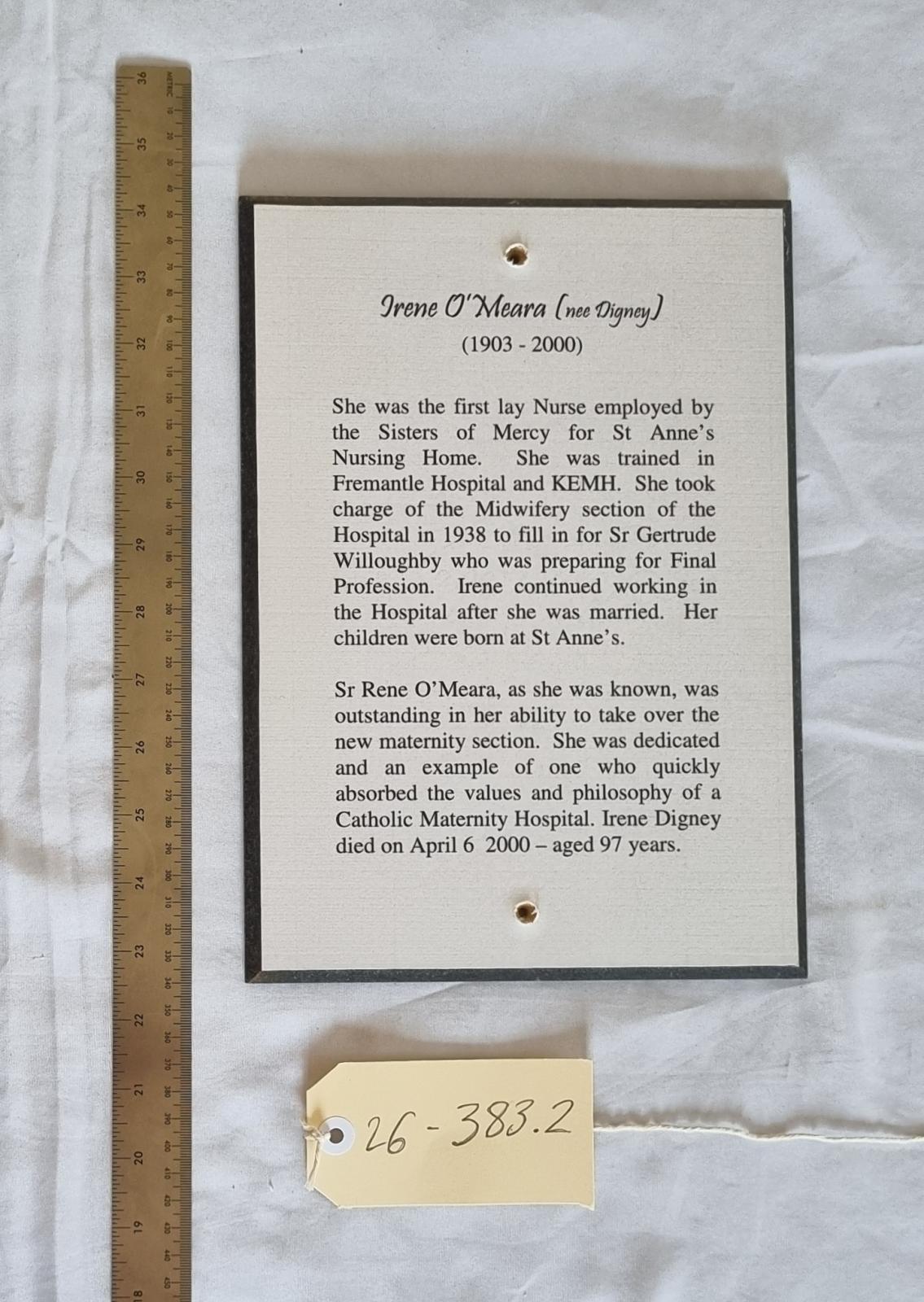 26-383.2 Woodblock-print of description of Irene O'Meara (nee Digney) photo with scale and tag. 