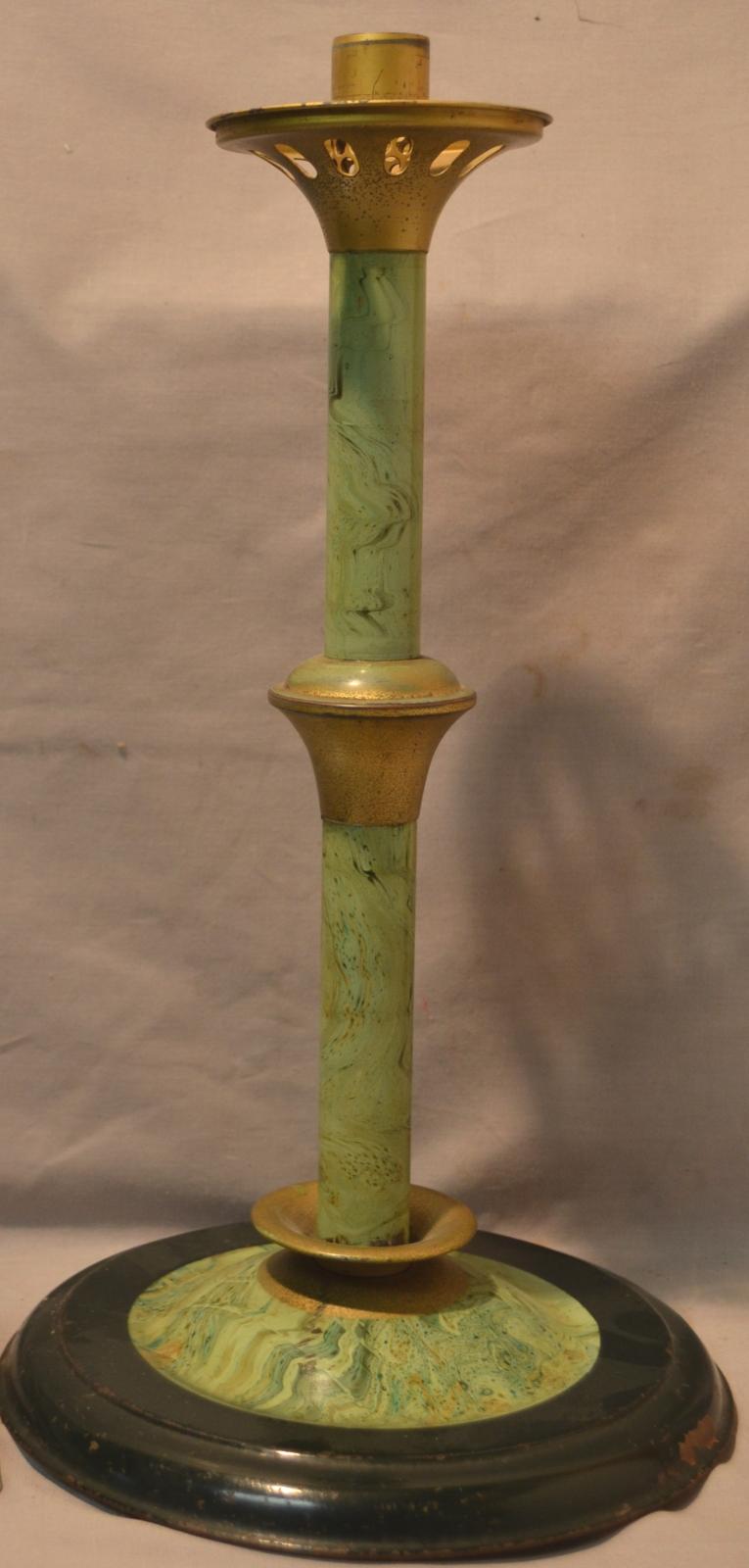 The stand has a wide, flattened-dome base with a hollow central column rising from the centre. The column has flaring, conical collars at the bottom, middle and top. The top collar is vented with oval-shaped holes and has to support the lamp burner. The outer ring of the base is very dark green with the rest of the item painted in a green marbled effect. The collars are gilt.