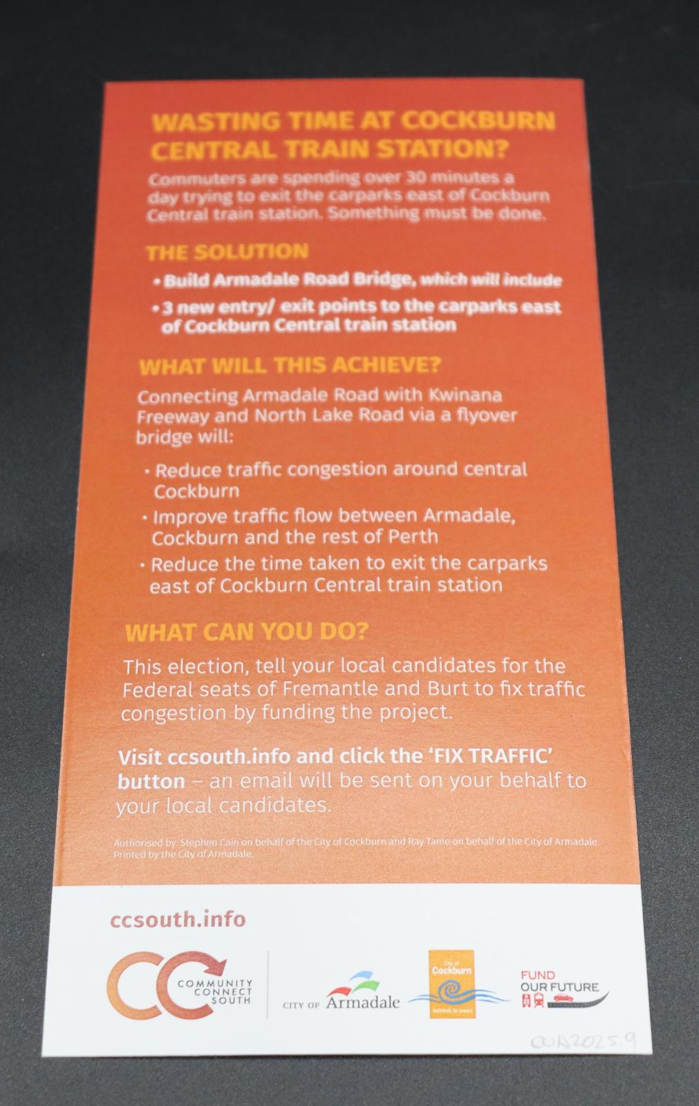 On the reverse side there are four text paragraphs, titled; [WASTING TIME AT COAKBURN CENTRAL TRAIN STATION],[THE SOLUTION],[WHAT WILL THIS ACHIEVE],[WHAT CAN YOU DO]. Text [VISIT CCSOUTH.INFO AND CLICK THE 'FIX TRAFFIC' BUTTON/ - AN EMAIL WILL BE SENT ON YOUR BEHALF TO YOUR LOCAL CANDIDATES]. White strip across bottom of right third with logos of the campaign, City of Armadale and City of Cockburn and Fund our future.