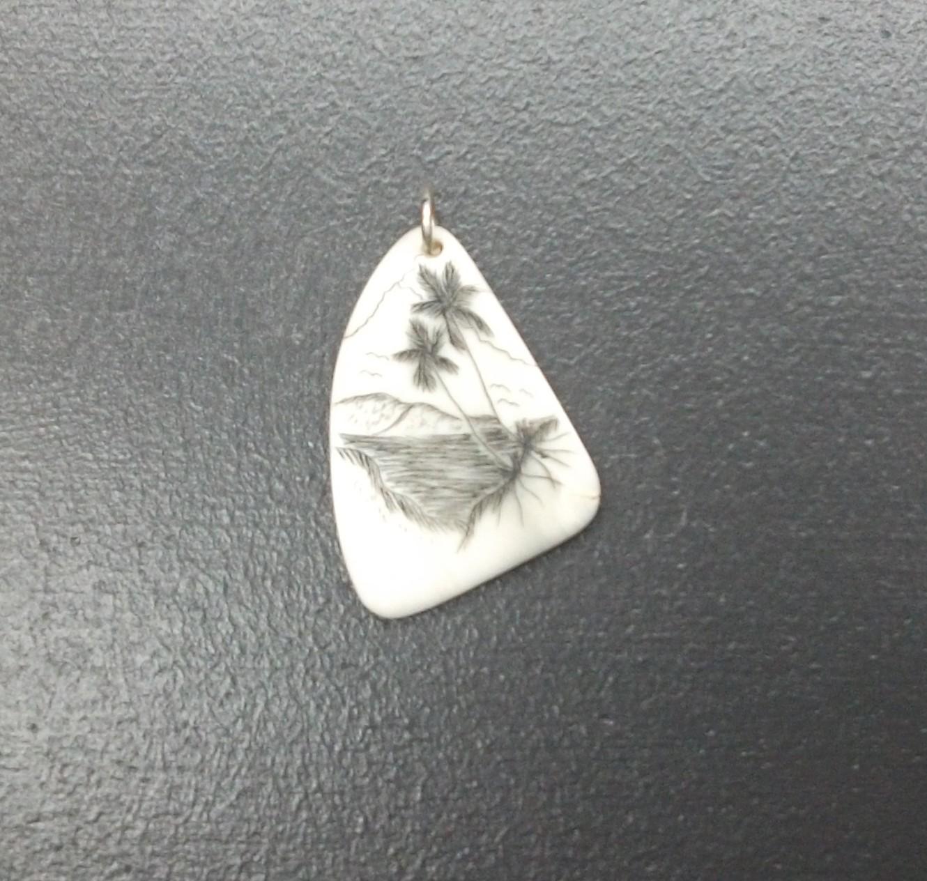 Carved pendant featuring two palm trees. 