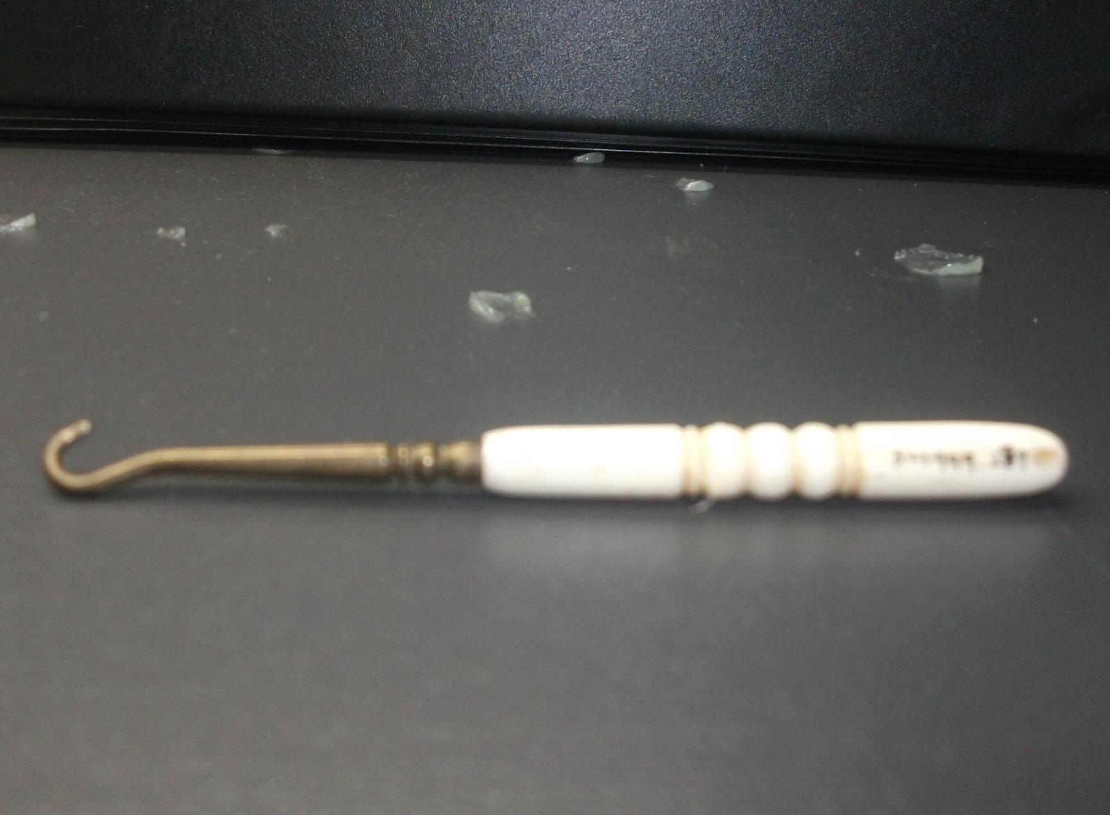 Button hook with a bone handle. 