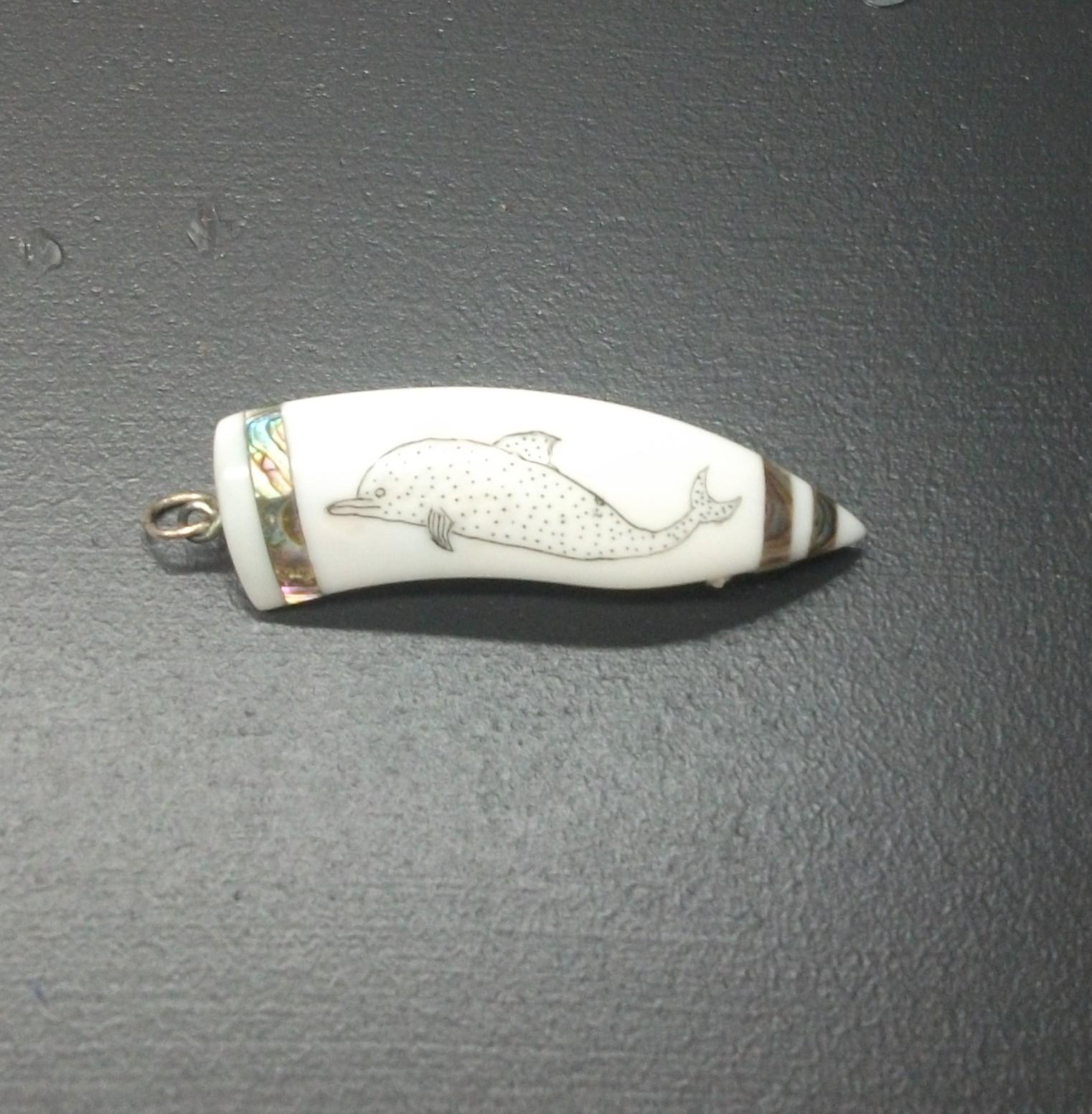 Ivory scrimshaw depicting a dolphin
