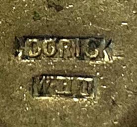 Maker's mark on reverse of badge