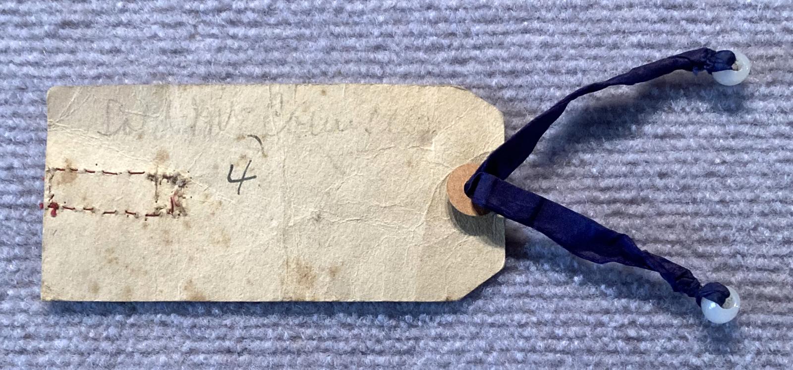 Reverse of WWI era patriotic tag with ribbon and verse