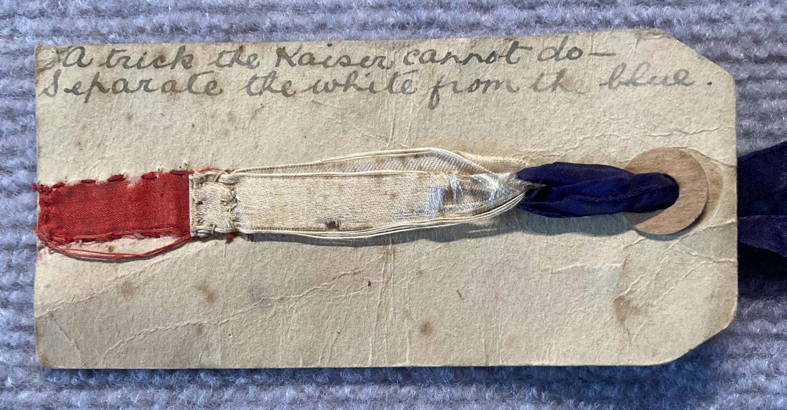 Close up of WWI era patriotic tag with ribbon and verse