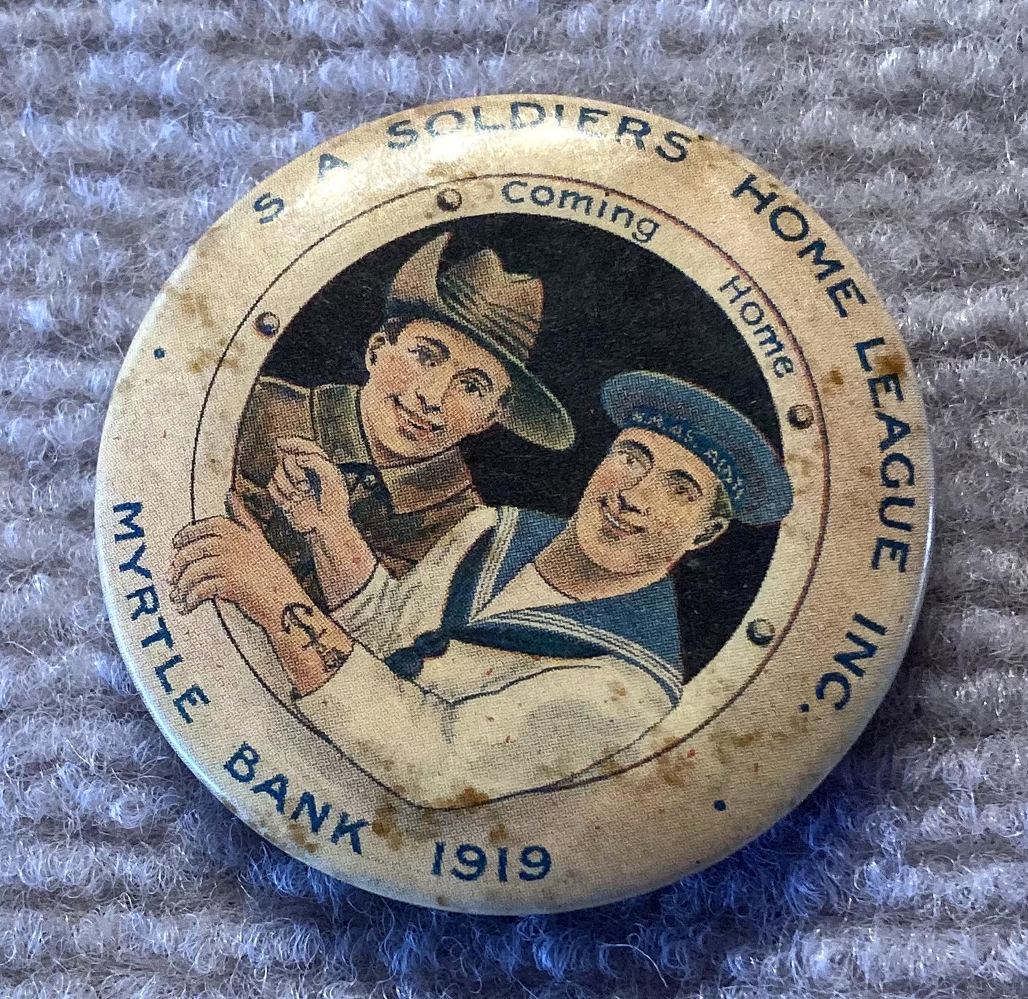 Angled view of S.A. Soldiers Home League Inc. large fundraising badge/button 