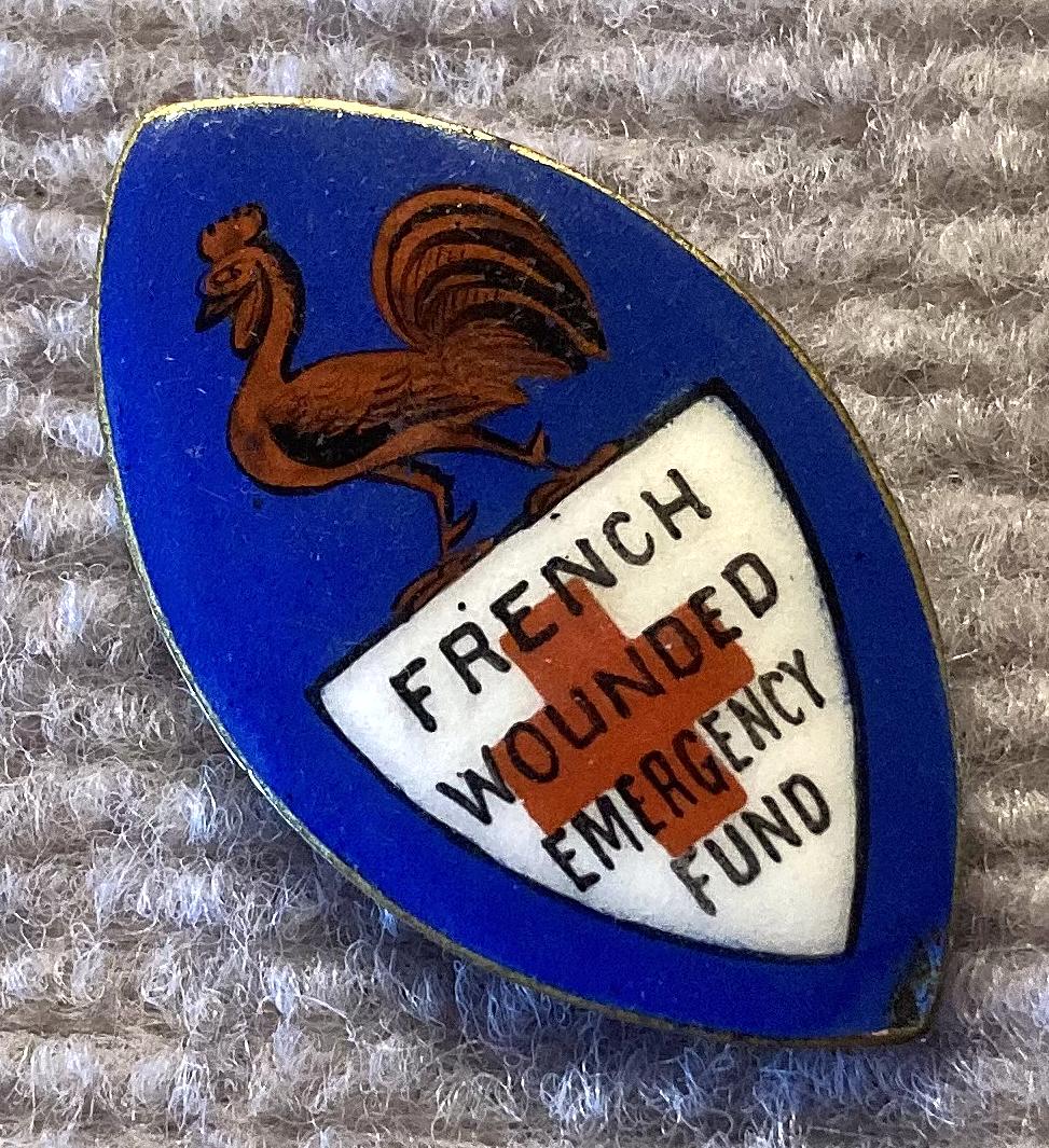 Angled view of WWI era French Wounded Emergency Fund enamel fundraising badge