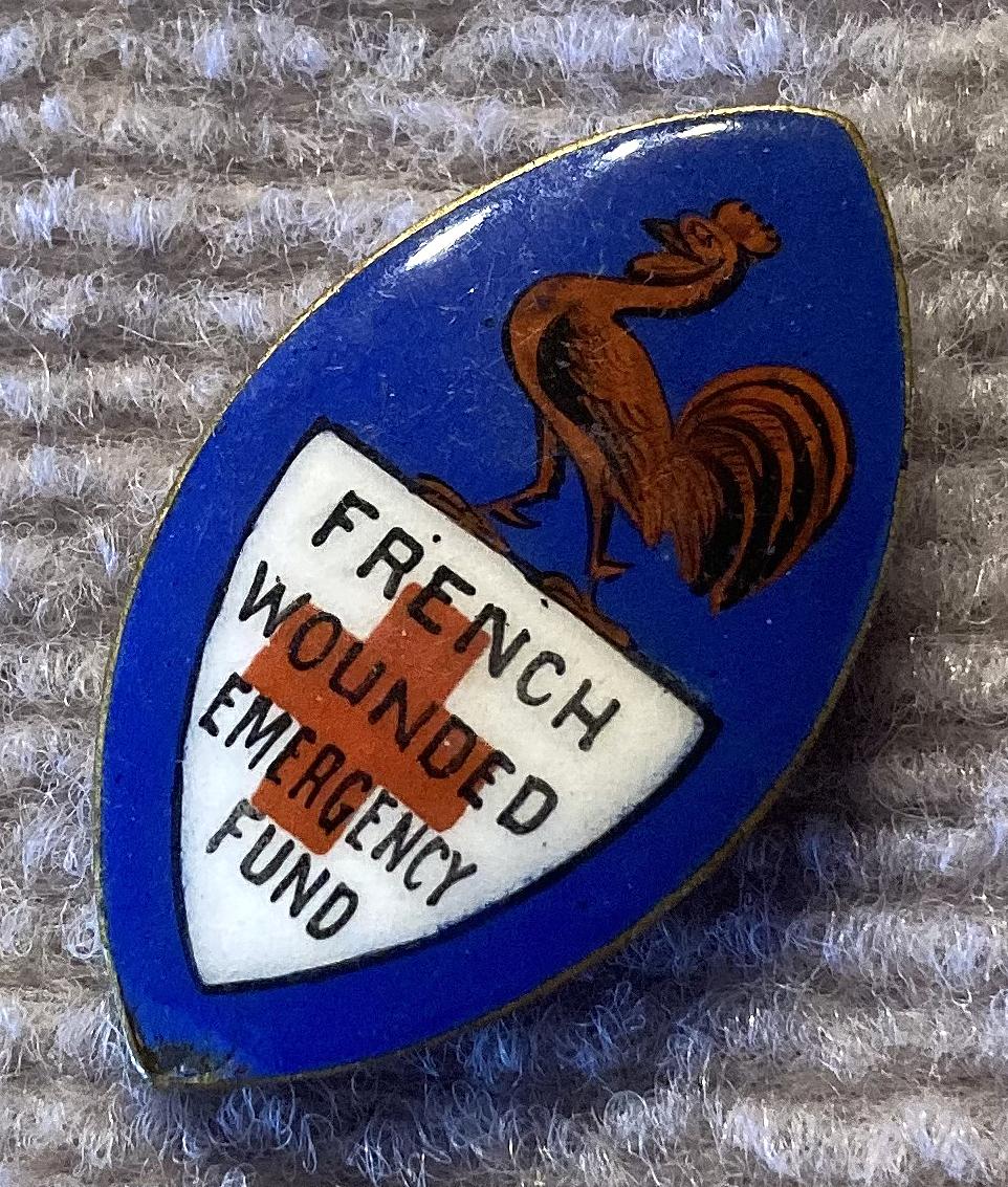 Other angled view of WWI era French Wounded Emergency Fund enamel fundraising badge