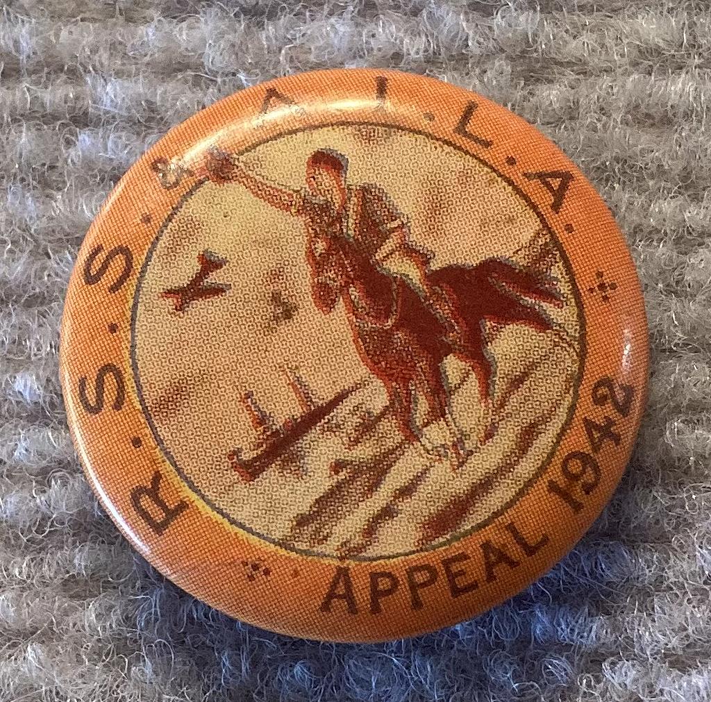 Angled view of R.S.S. & A.I.L.A. fundraising badge/button - 1942