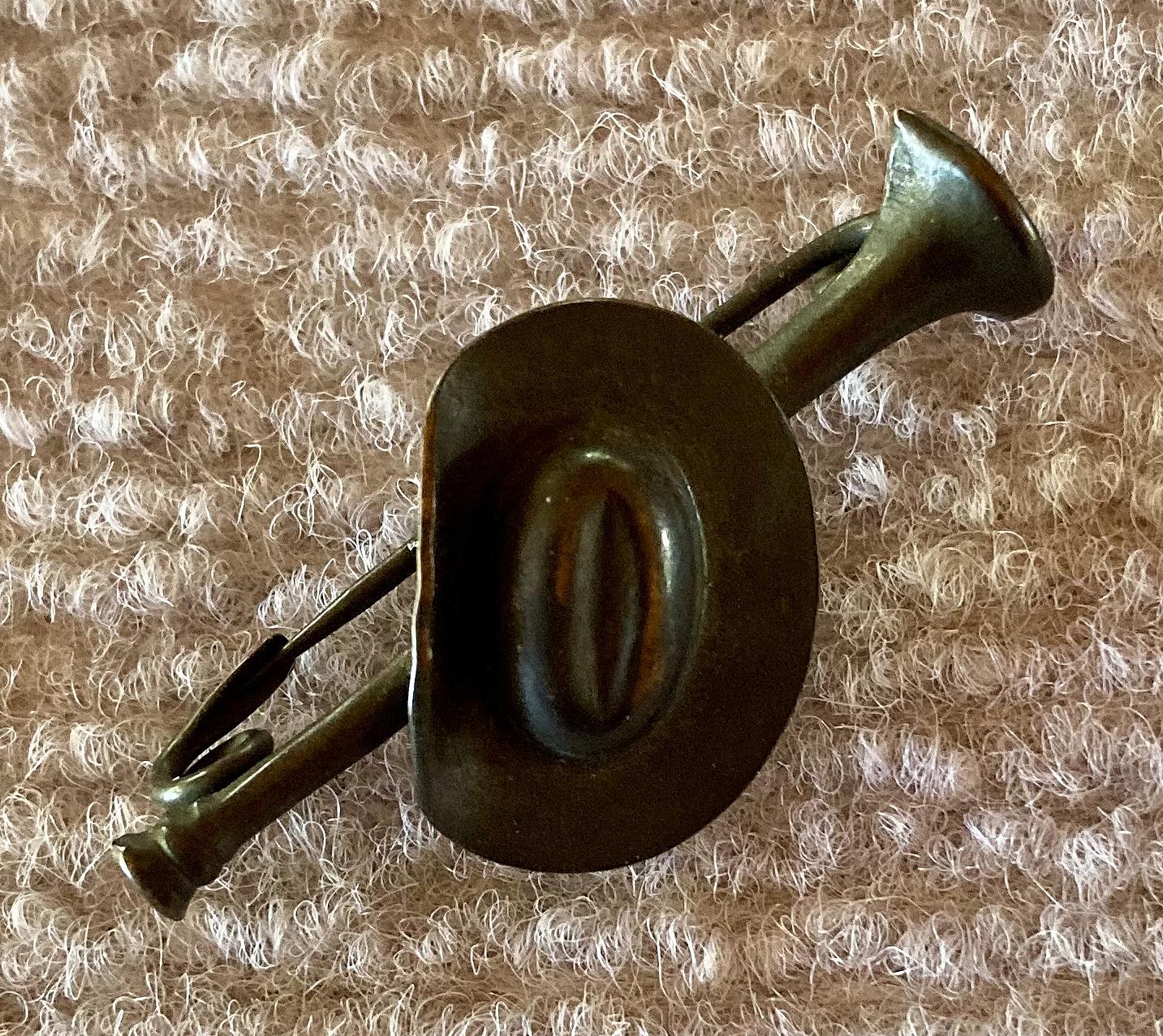 Other angled view of metal slouch hat mounted on bugle sweetheart brooch