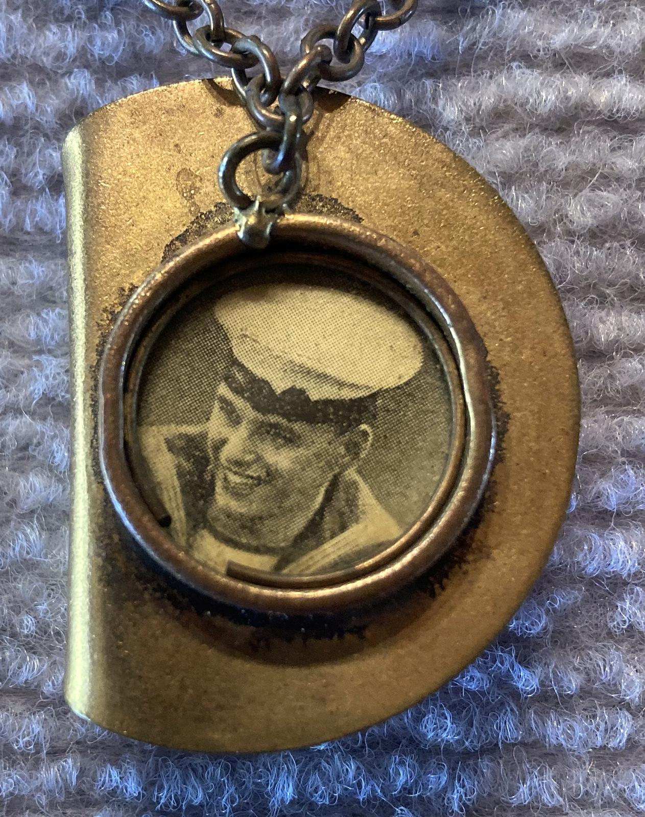 Close up of slouch hat sweetheart brooch containing sailor portrait 