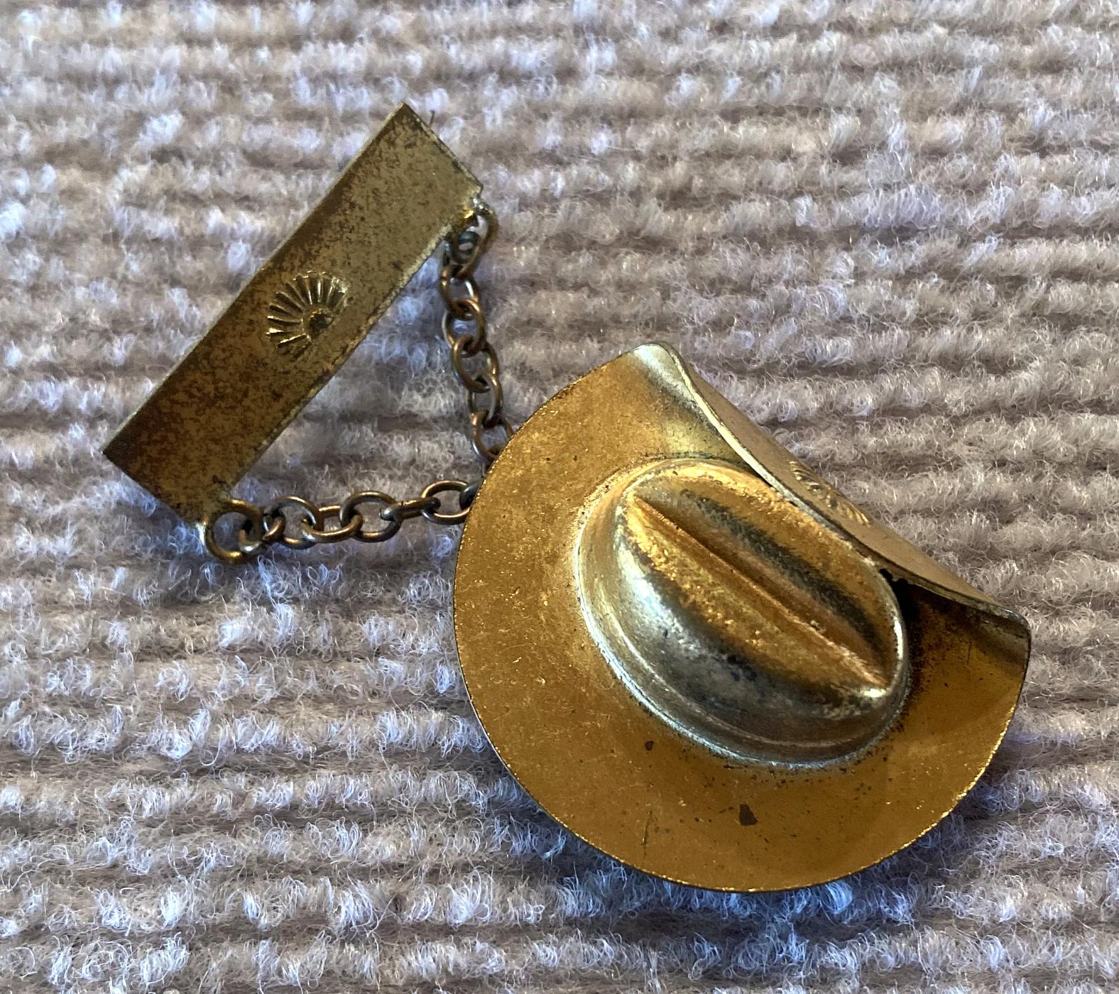 Angled view of reverse of slouch hat sweetheart brooch containing sailor portrait 