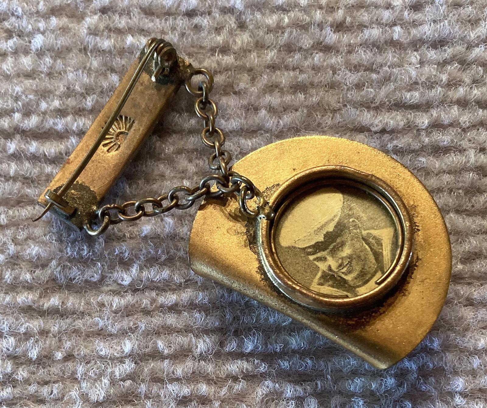 Angled view of slouch hat sweetheart brooch containing sailor portrait 