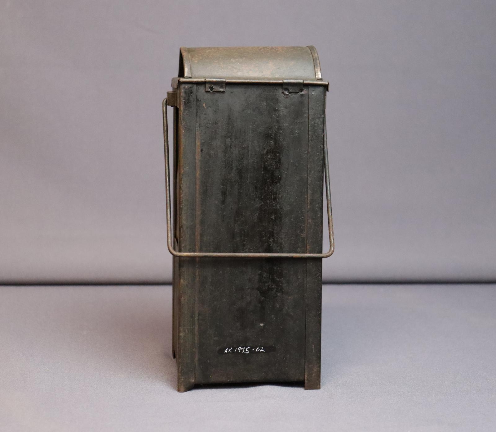 Rectangular metal case with a squared handle at top