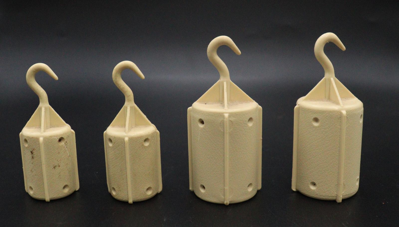 4 cream-coloured plastic weights (in 2 different sizes) for the BROTHER knitting machine. All the weights have curved hooks at the top.