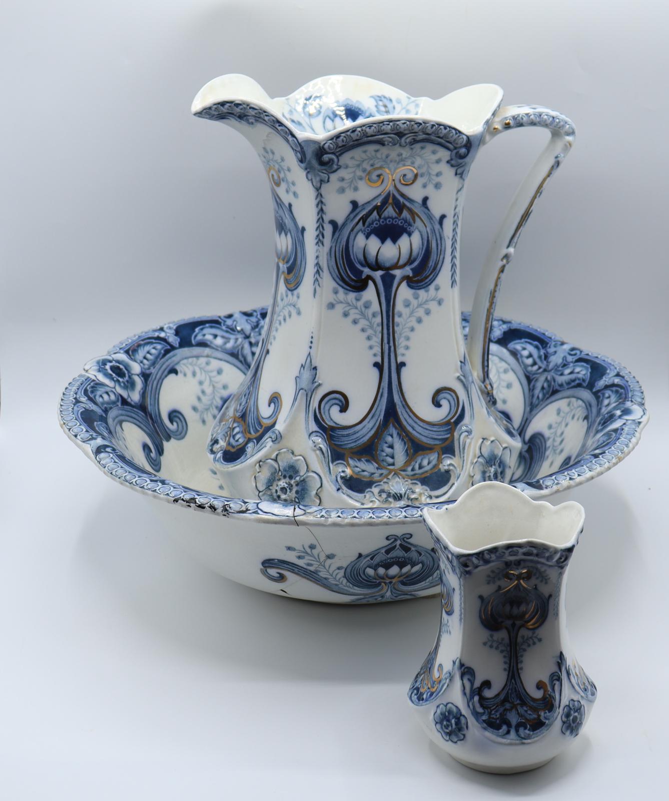 A 3-piece, white and blue ceramic set of earthenware, consisting of a large jug, a large bowl or wash basin, and a small vase.
