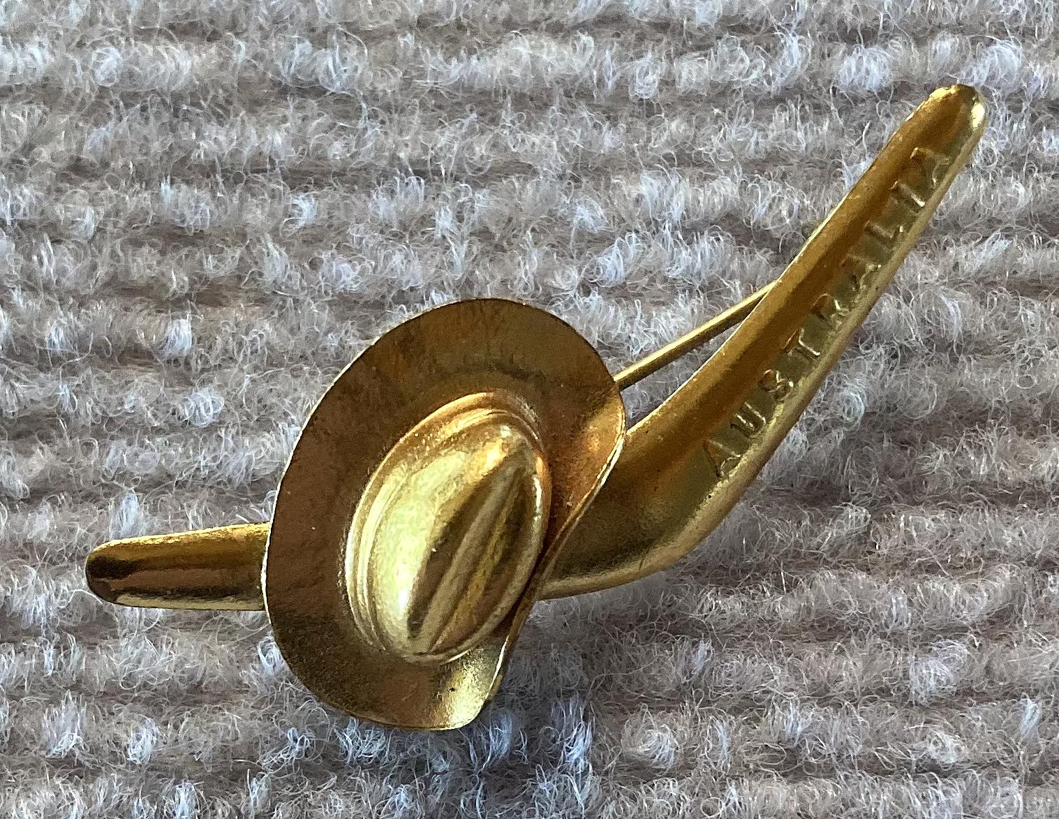 Other angled view of gold tone patriotic brooch with slouch hat and boomerang