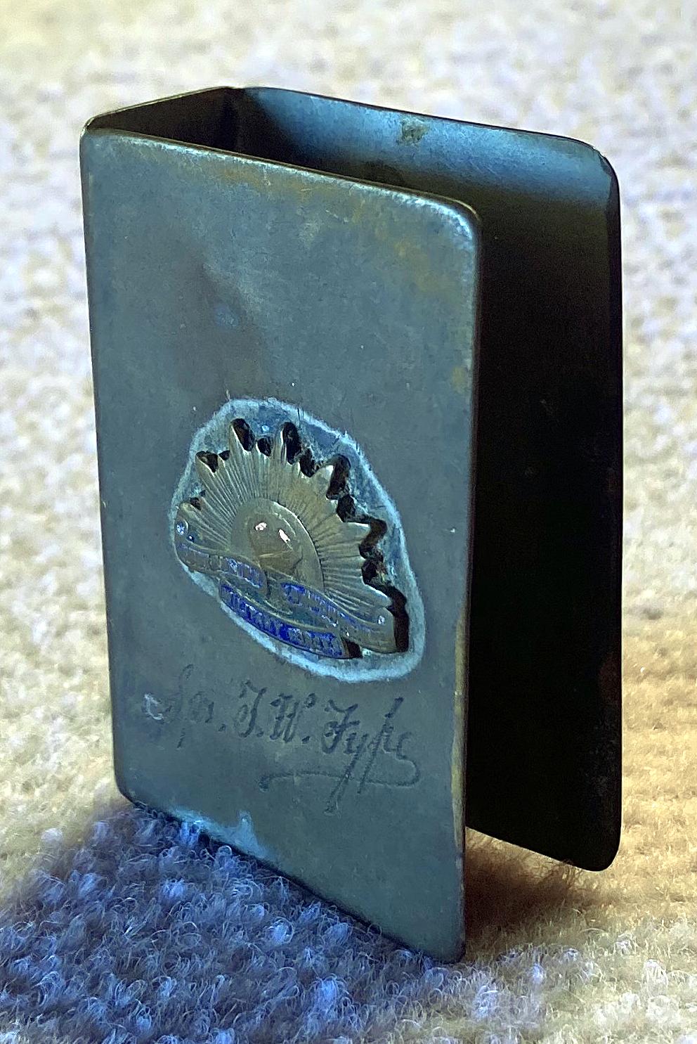 Angled view of upright WWII metal matchbox cover -  Sapper Thomas Walter Fyfe