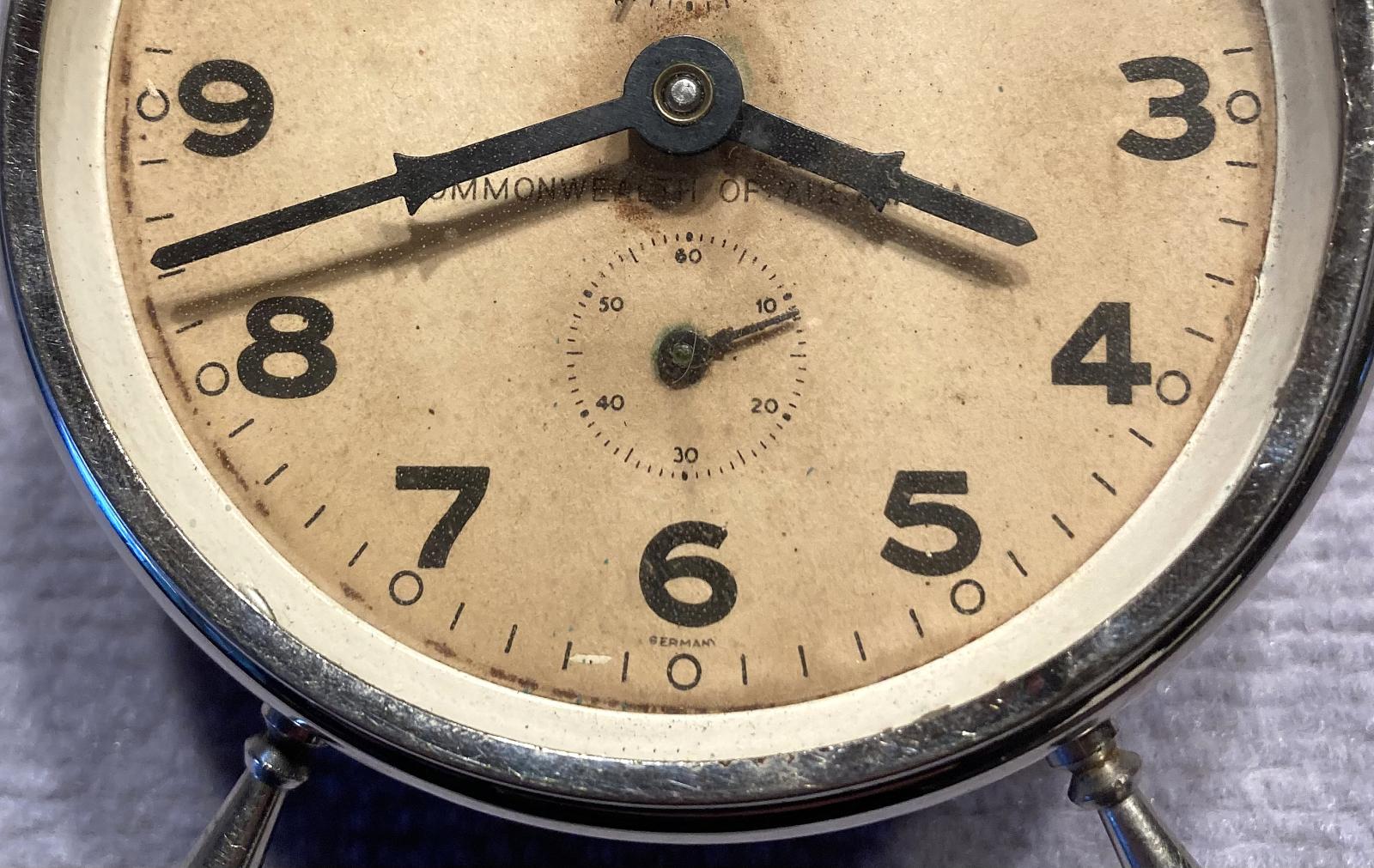 Close up of lower section of face of Commonwealth of Australia alarm clock 