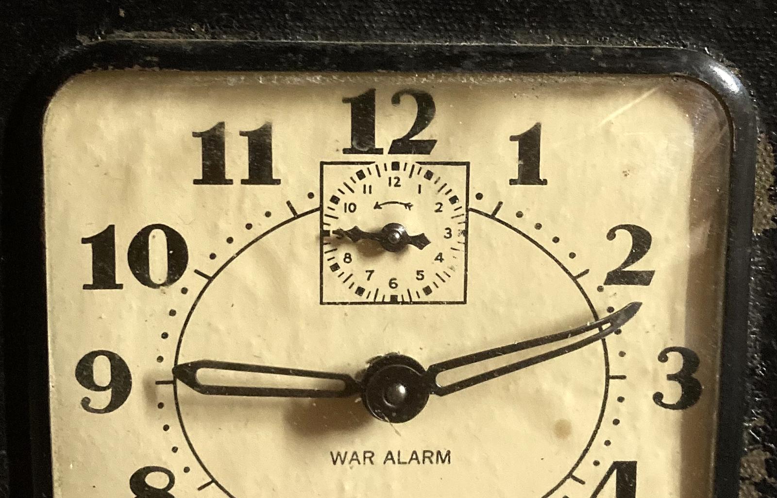 Close up of upper section of face of War Alarm clock 