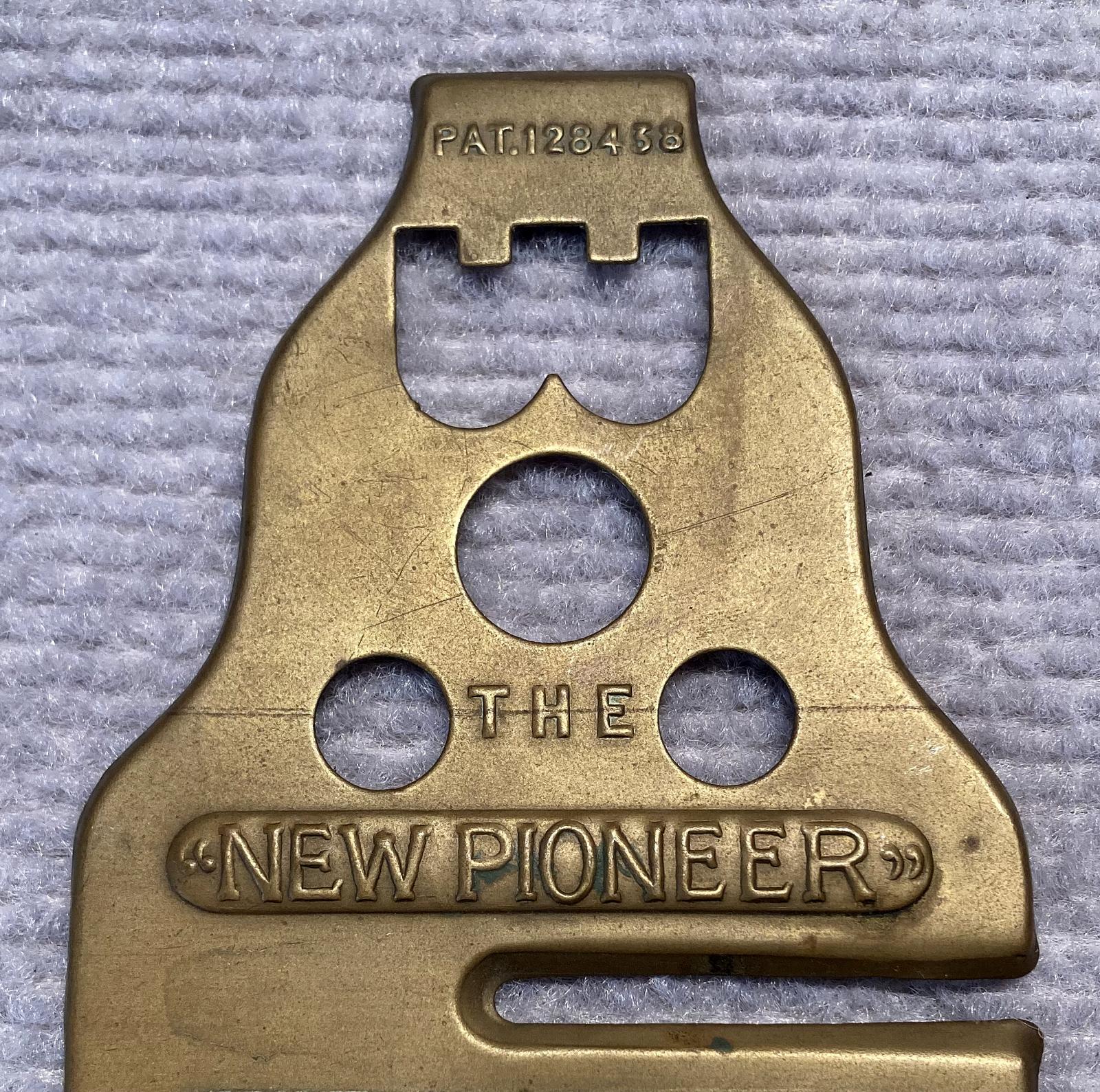 Close up of upper section of WWI era 'New Pioneer Equipment Protector' brass button stick