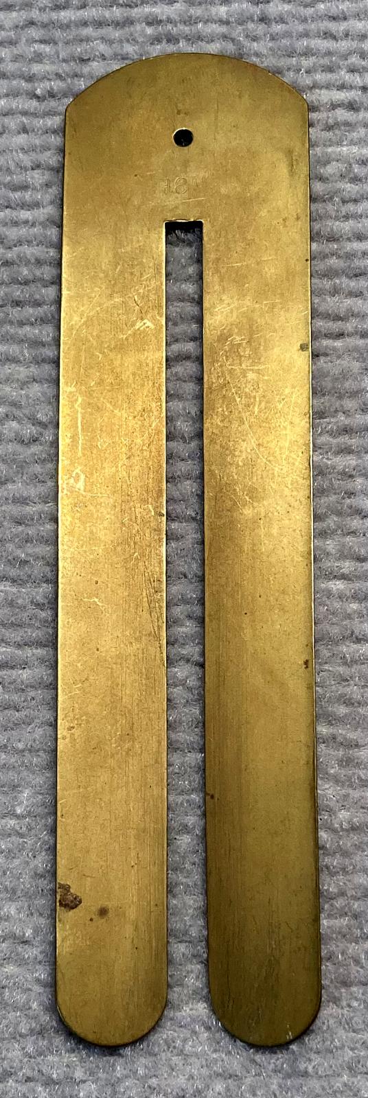 Reverse of WWI era brass button stick made by M.S.F.