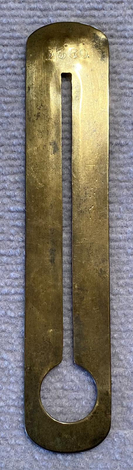 Reverse of antique brass button stick engraved with name - J. Harrop