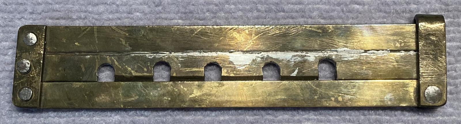 Other side of hand made WWI hinged brass button stick - closed