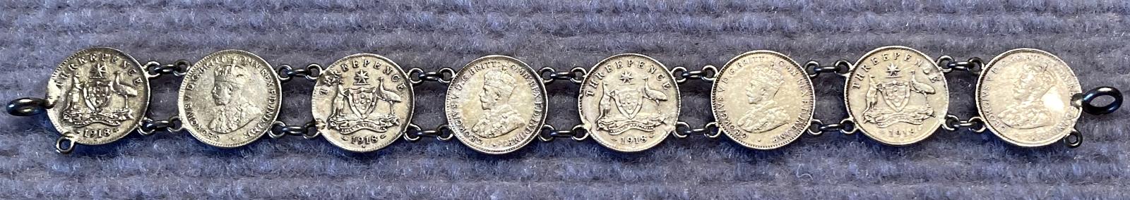 One side of WWI era trench art coin bracelet