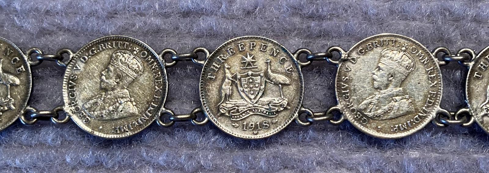 Close up of one side of WWI era trench art coin bracelet