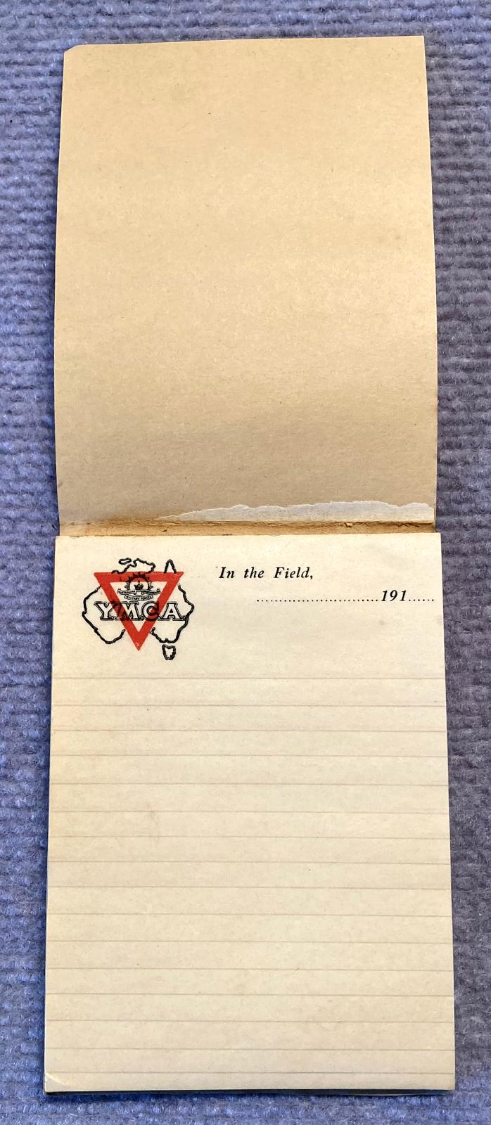 Open notepad showing lined paper with Y.M.C.A. logo