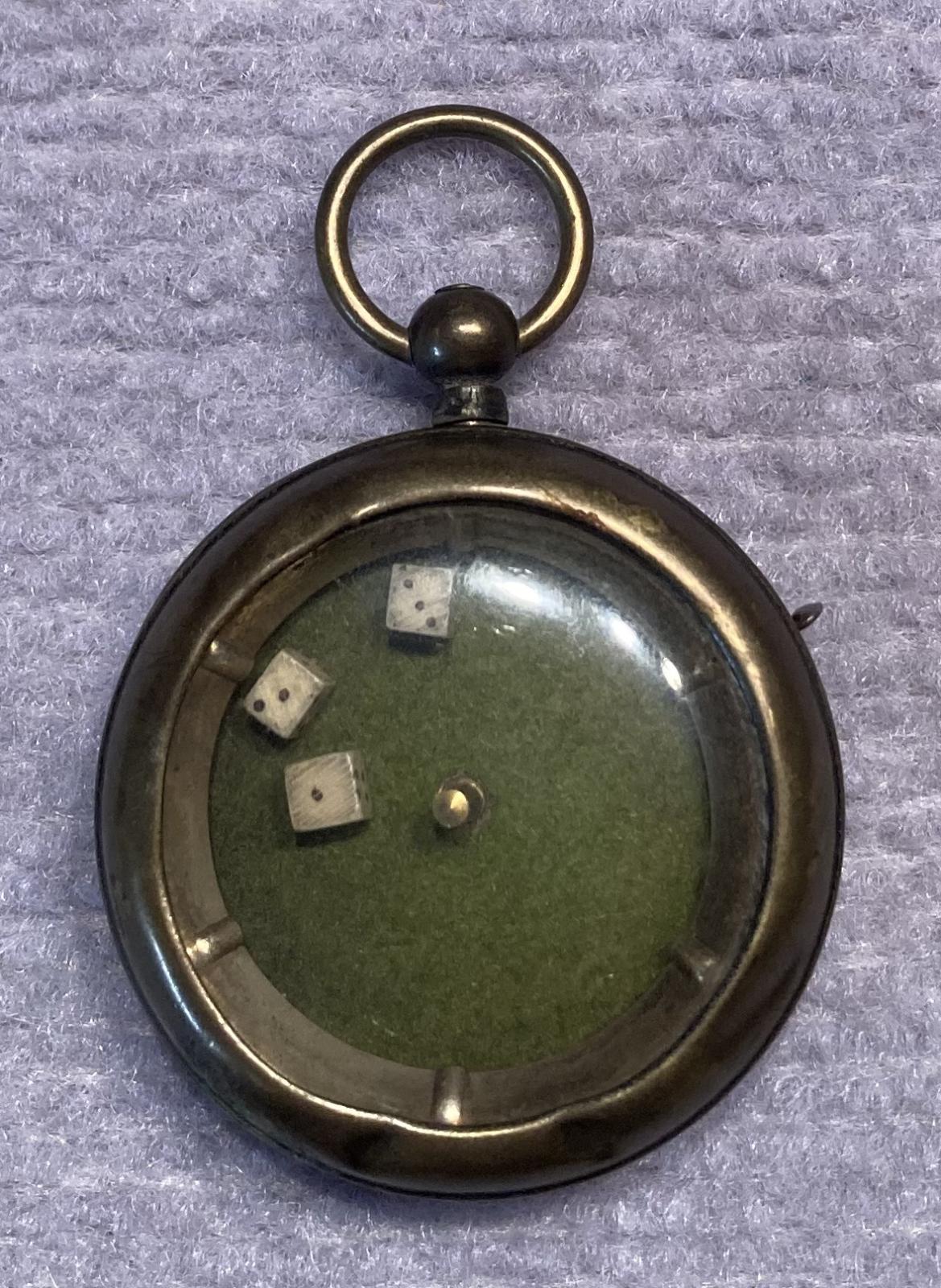 Mechanical dice game encased in a pocket watch housing