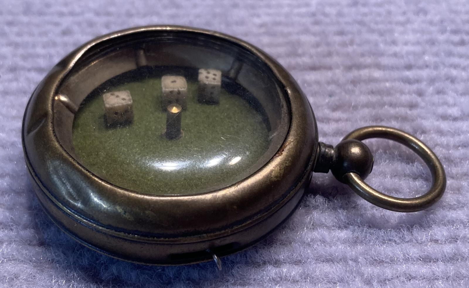 Other side view of mechanical dice game encased in a pocket watch housing