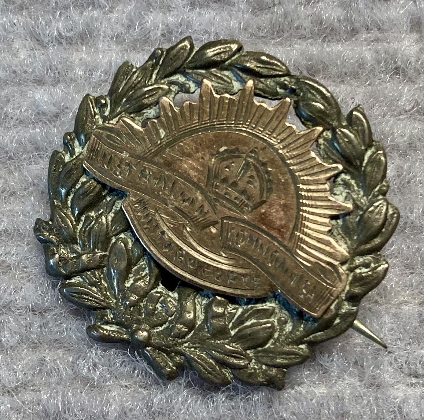Other angled view of metal sweetheart brooch featuring a Rising Sun badge on a wreath