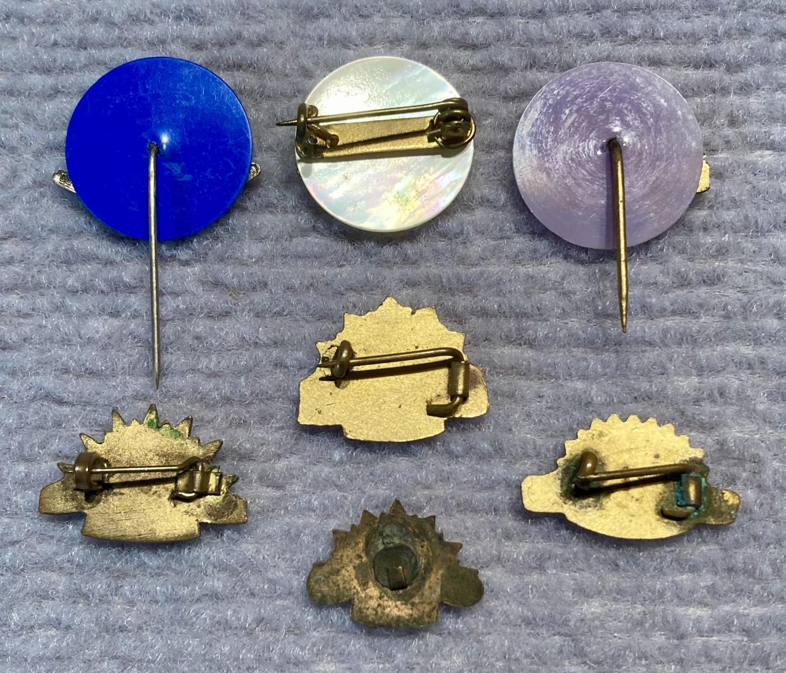 Reverse of group of miniature Rising Sun badge brooches and stick pins