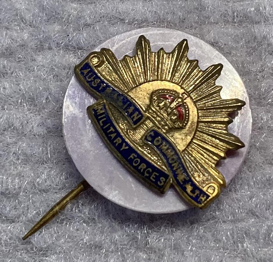Other angled view of miniature Rising Sun badge stick pin on lilac backing
