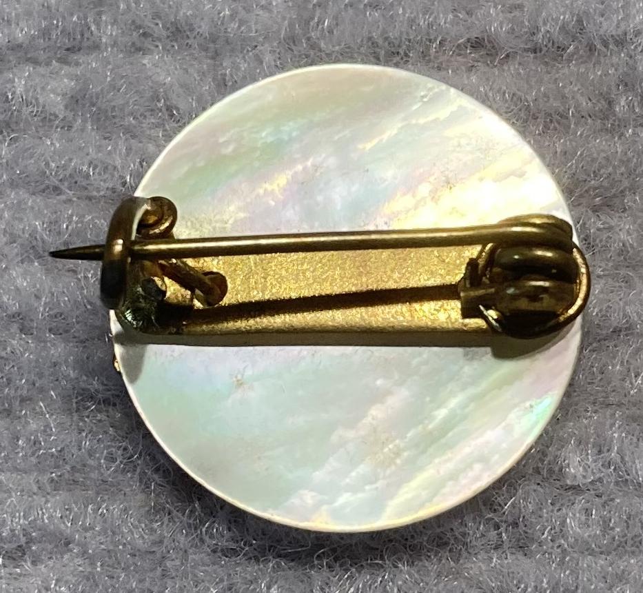 Reverse of miniature Rising Sun badge brooch with mother of pearl backing