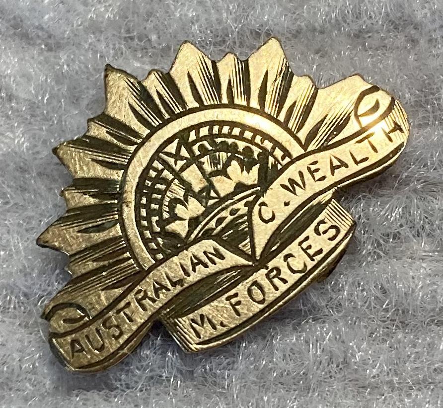 Angled view of miniature Rising Sun badge engraved metal plaque