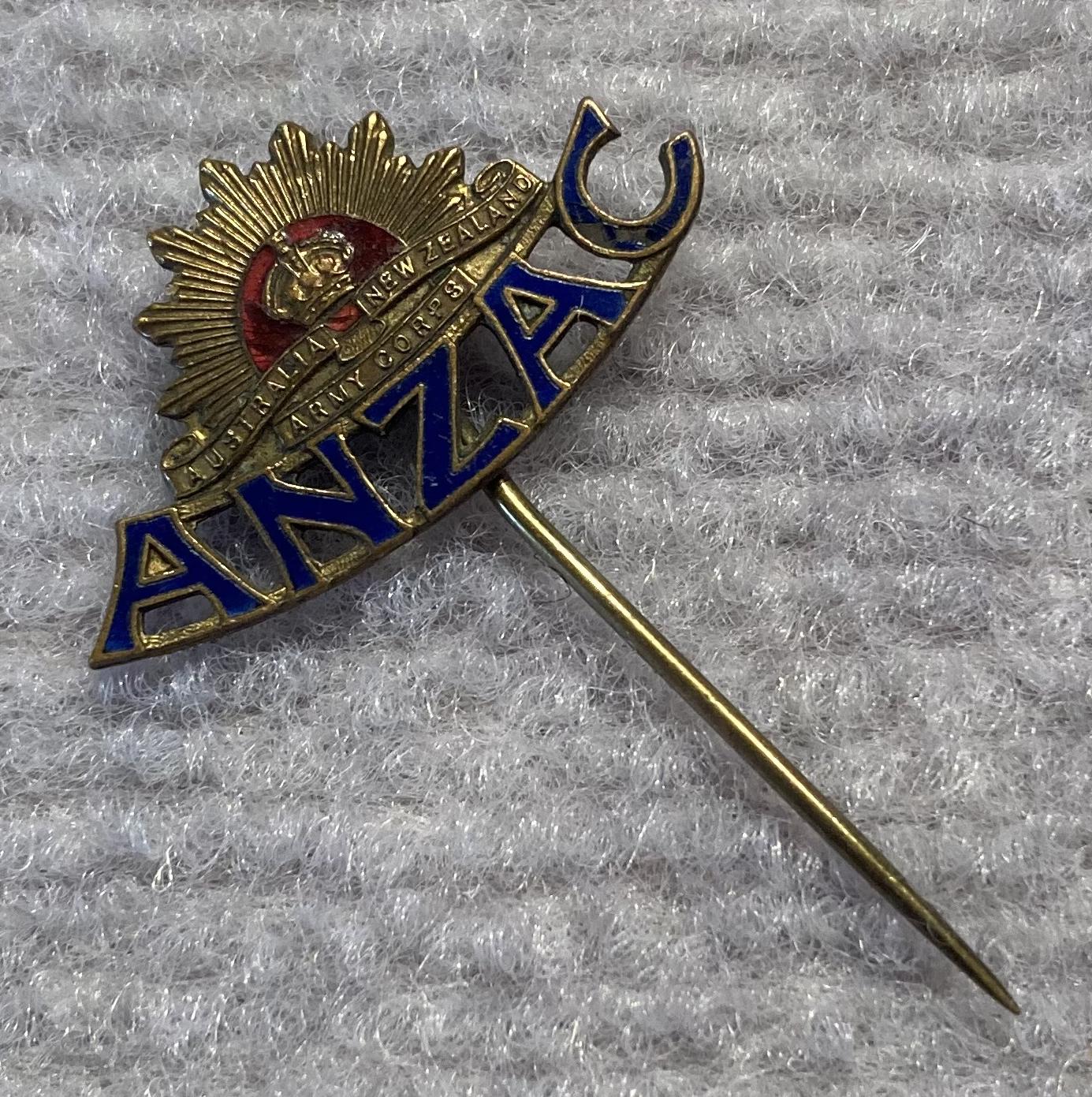 Angled view of WWI era brass and enamel ANZAC sweetheart stick pin