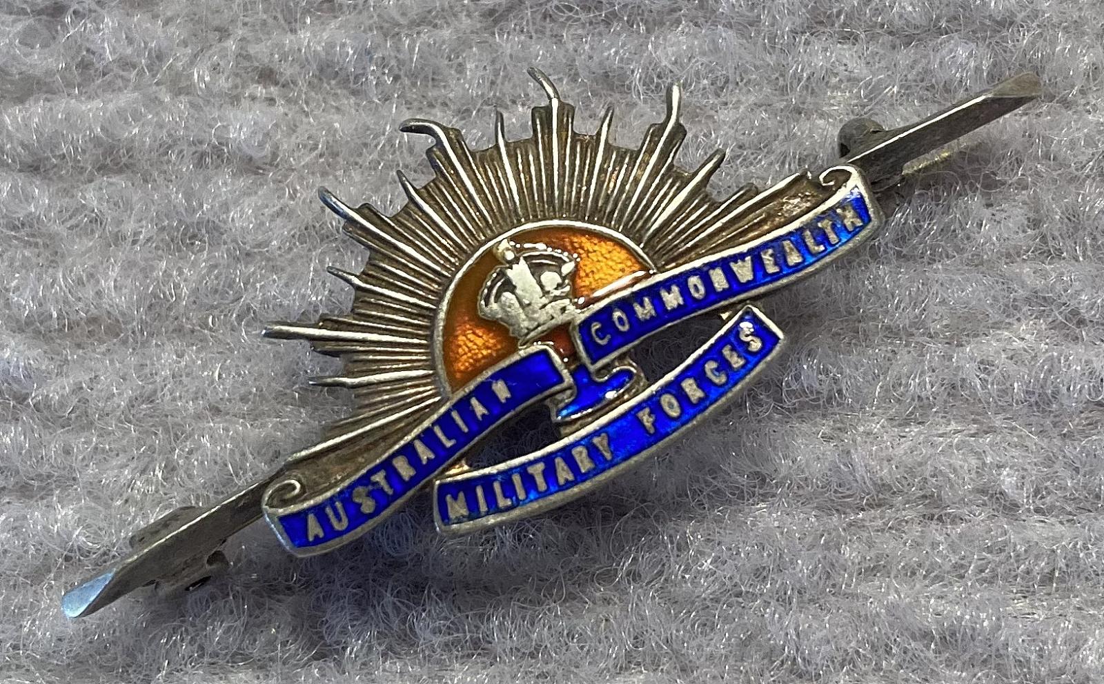 Angled view of sterling silver and enamel Rising Sun badge sweetheart brooch