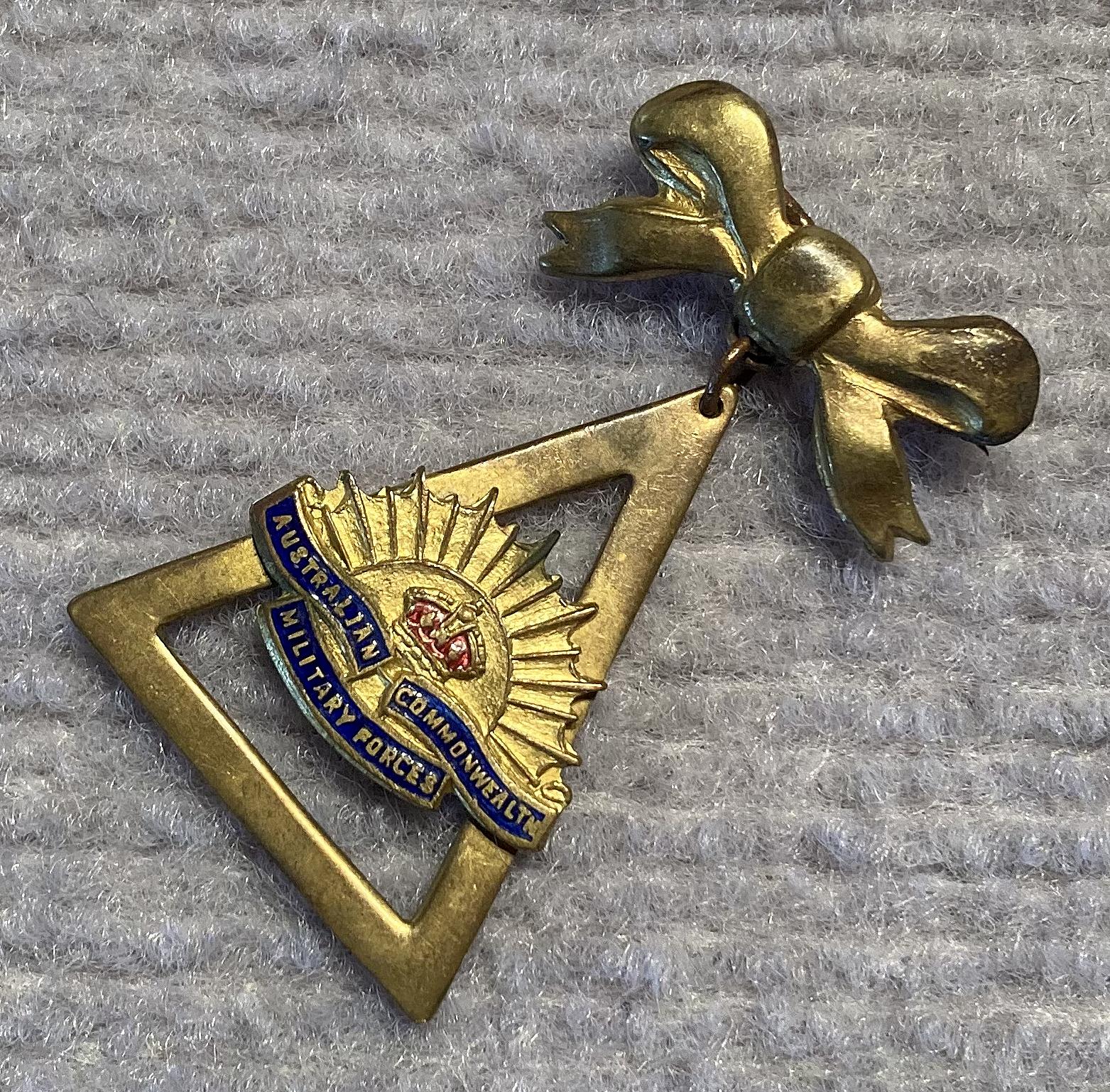 Other angled view of gold tone metal and enamel Rising Sun badge sweetheart brooch