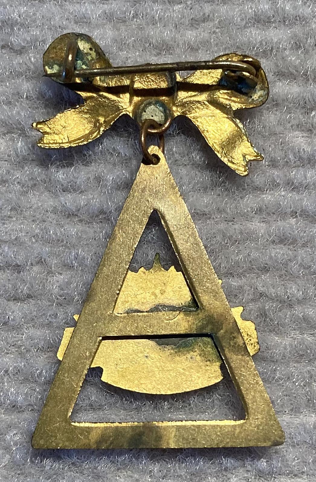 Reverse of gold tone metal and enamel Rising Sun badge sweetheart brooch