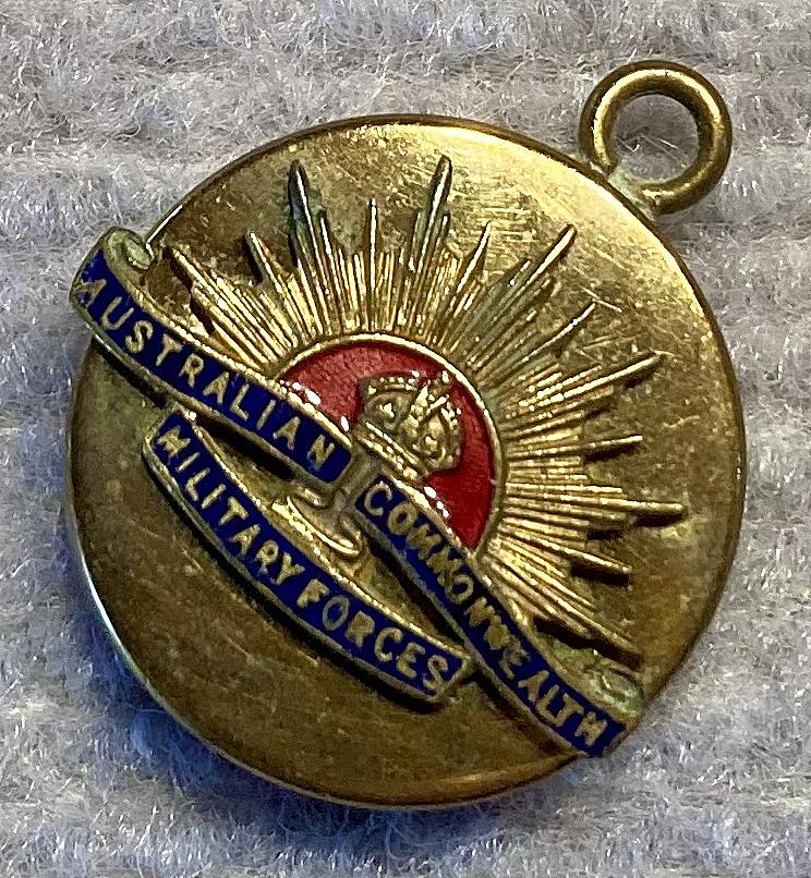 Other angled view of gold tone metal and enamel Rising Sun badge sweetheart pendant locket 