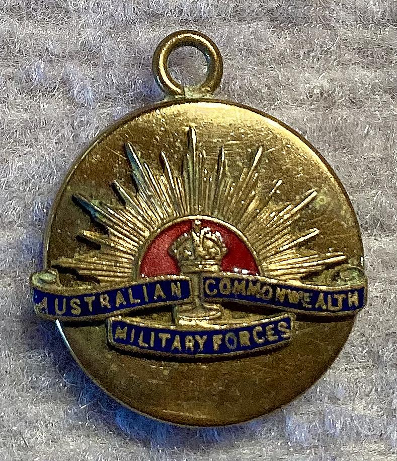 Gold tone metal and enamel Rising Sun badge sweetheart pendant locket 