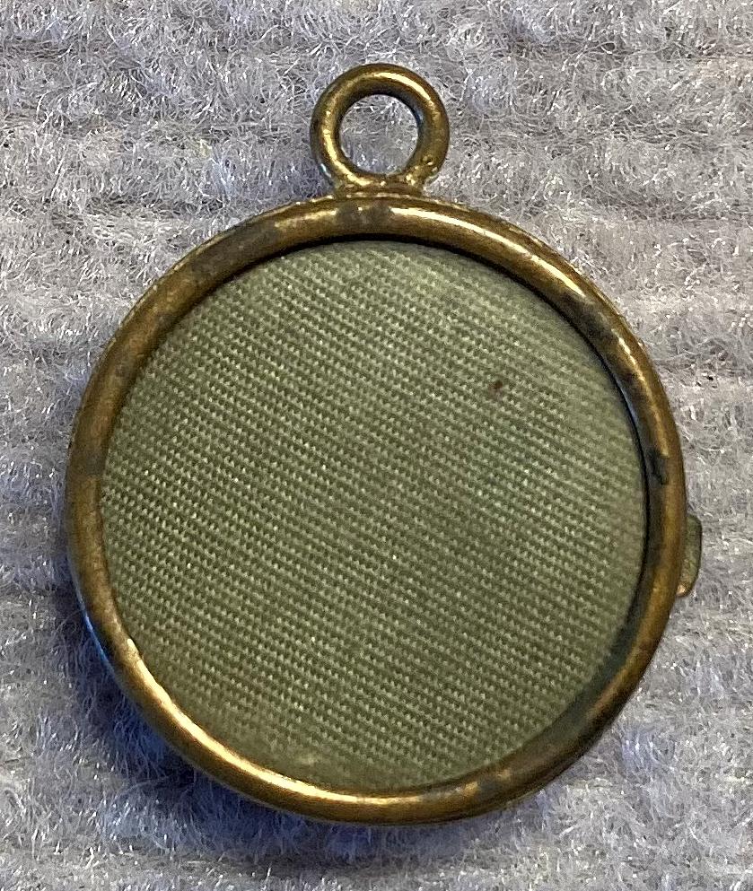 Reverse of gold tone metal and enamel Rising Sun badge sweetheart pendant locket 