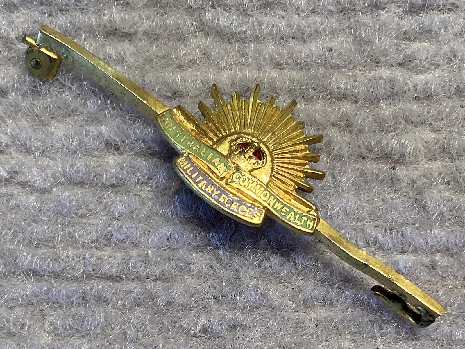 Other angled view of gold tone metal and enamel Rising Sun badge sweetheart lapel brooch/tie pin