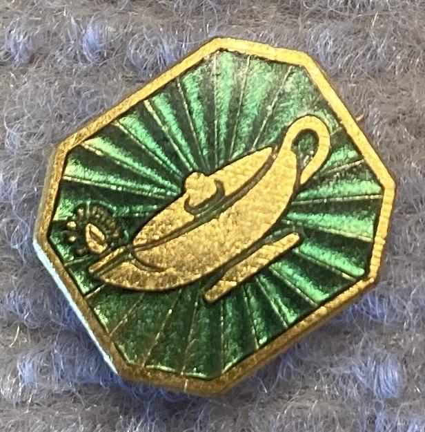 Angled view of Scripture Union gold tone metal and enamel fundraising brooch