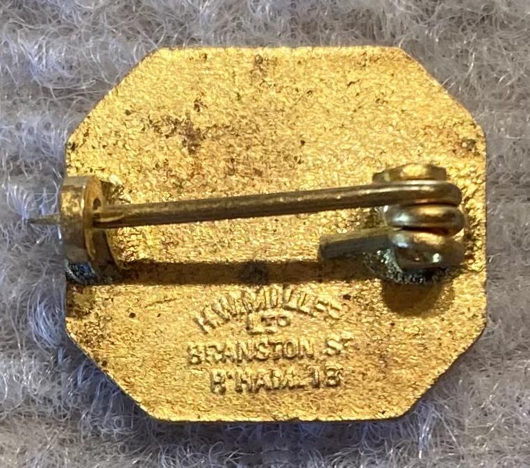 Reverse of Scripture Union gold tone metal and enamel fundraising brooch